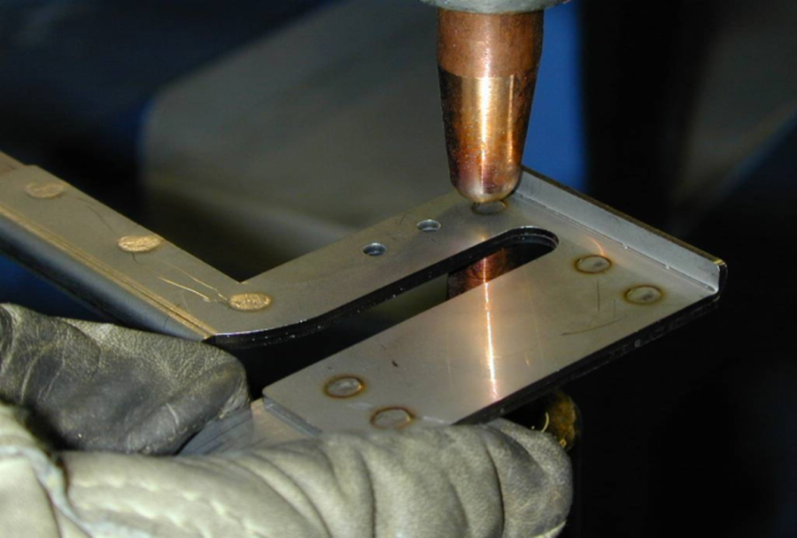 Spot welding metal sheets together with precision.