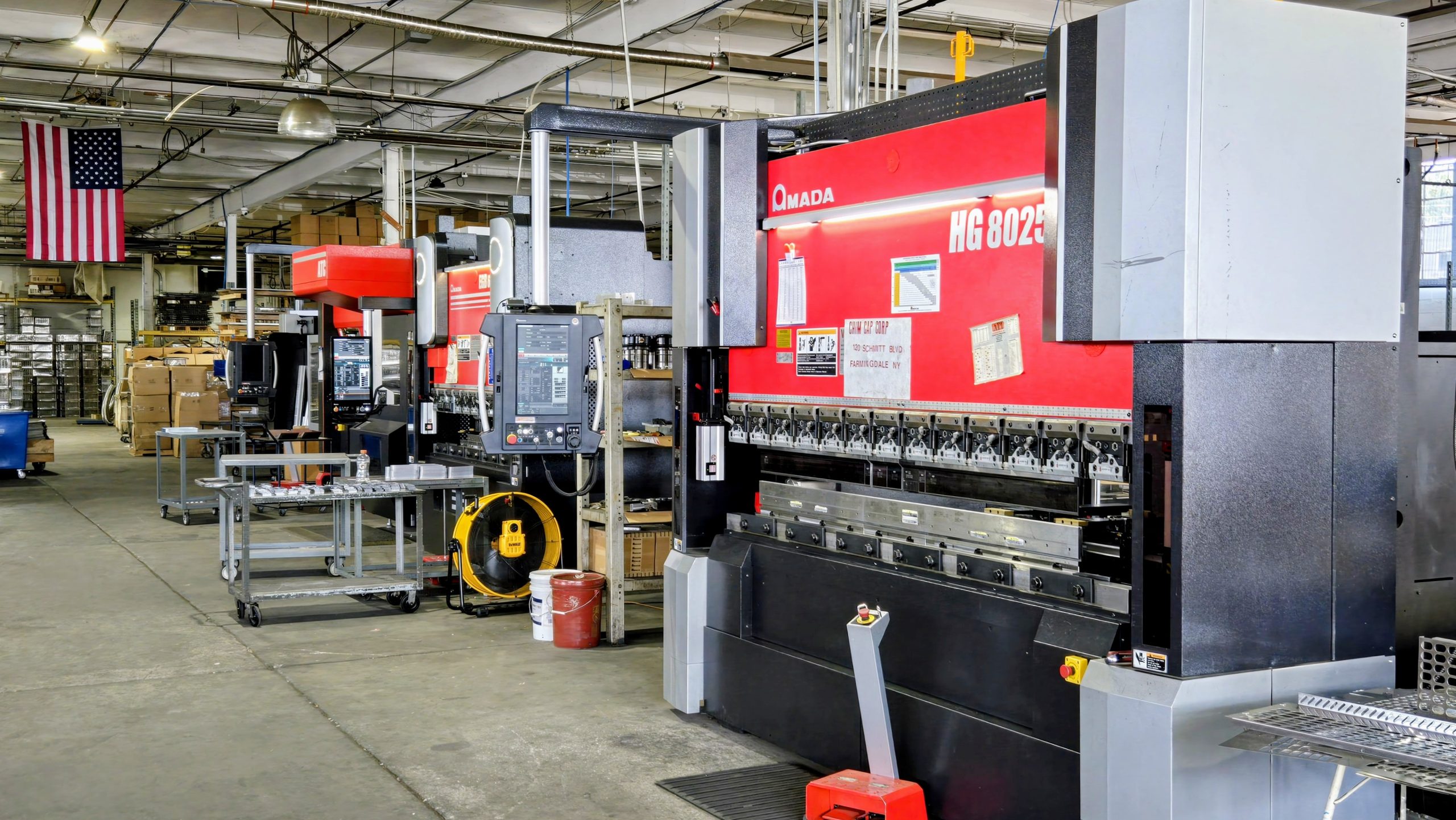 Automatic machine drilling holes in metal plate.